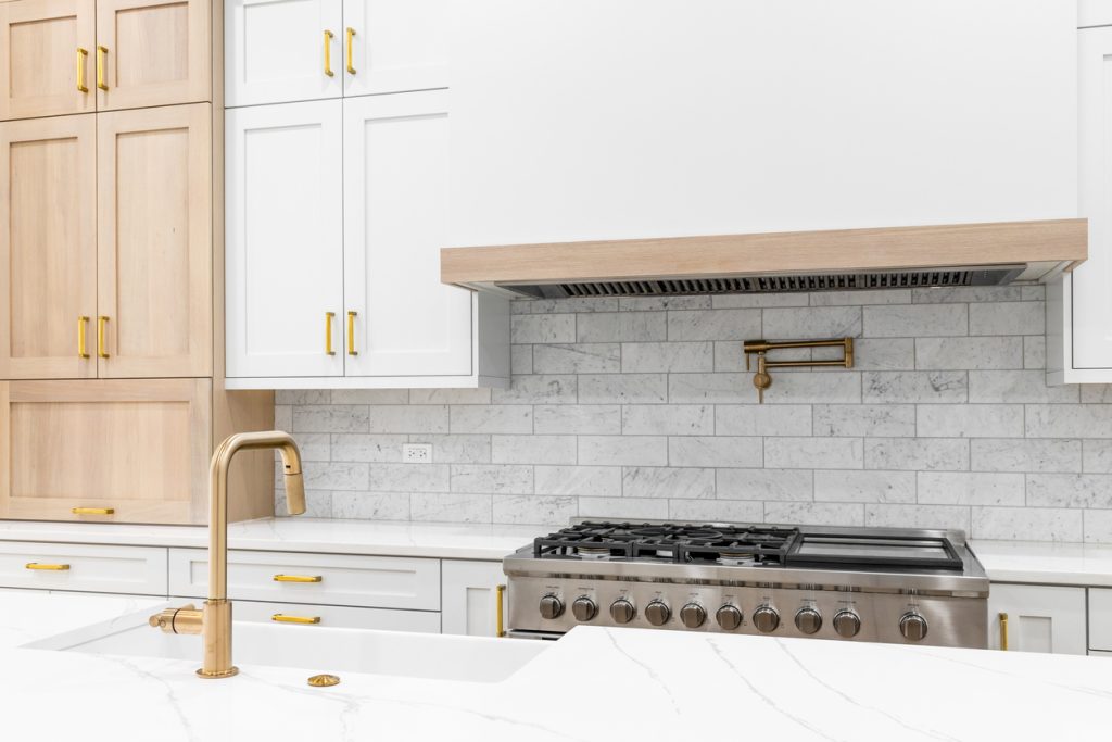 Kitchen cabinets trend using gold hardware